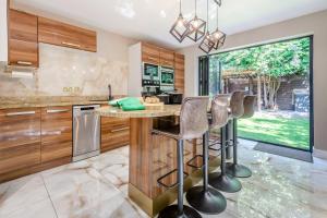a kitchen with a island with bar stools at Palm Beach House in Mudeford +27 photos