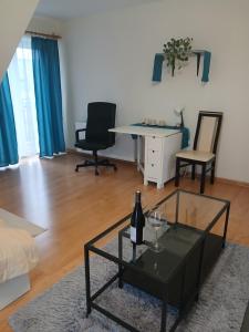 a living room with a bottle of wine on a table at Zielony Gaj in Gaj +25 photos