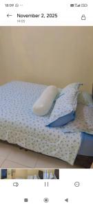 two pictures of a bed with pillows on it at Coach homestay 2 in Kuantan