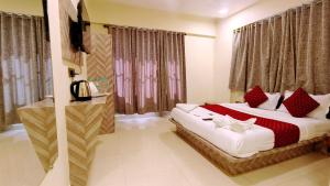 a bedroom with a large bed with red and white pillows at Smooth Checkin By Edition Blue - Mumbai in Mumbai
