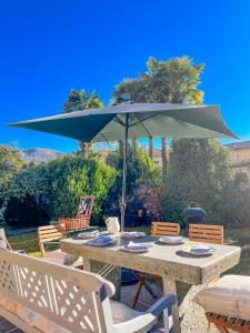 a table with a green umbrella and chairs at Casa Tranquilla in Cannobio