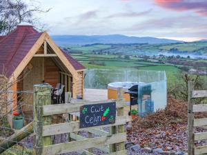 a sign in front of a tiny cabin at Cwt Celyn Qu7605 in Llangernyw
