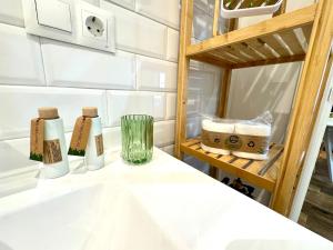 a room with a table with two bottles and a shelf at Gestviva Casa Urbanin I in Cudillero +36 photos