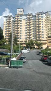 a parking lot in front of a large building at Homstay Cameron Highlands in Cameron Highlands