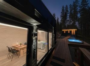 a house with a deck with a bedroom on it at Spa Cabin by Hossaville in Hossa