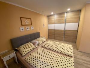 a bedroom with a large bed with a large window at Apartmán u Kuľky in Spišské Bystré +8 photos