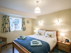 En eller flere senge i et værelse på The Corn House - Cottage