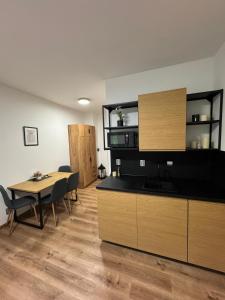 Una cocina y un comedor con mesa y sillas. en Apartmány Mikulov 45, en Mikulov v Krušných Horách