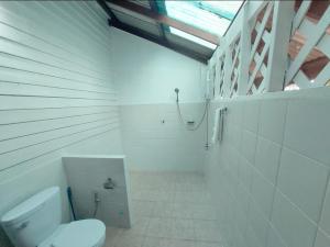 a white bathroom with a toilet and a shower at Wooden House On The Bay in Ban Bang Chak +46 photos