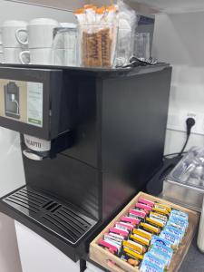 a coffee maker with a tray of hot dogs at Hotel Wayteko San Antón in Alicante
