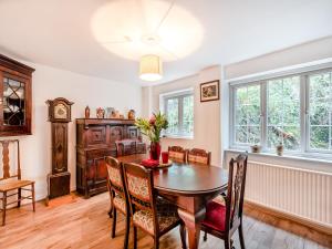 a dining room with a table and chairs at Ty Newydd Y Graig - 28017 in Tremeirchion +16 photos