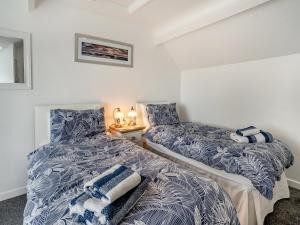 two beds sitting next to each other in a room at Stable Cottage - Uk10694 in Amroth +26 photos