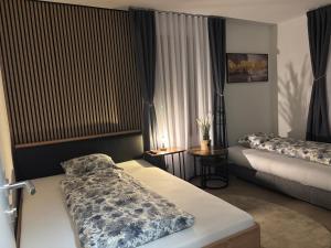 a hotel room with two beds and a window at Bellavista Home in Trimbach