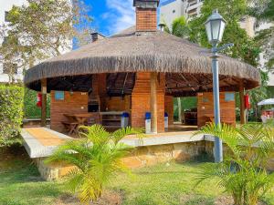 a hut with a table and a street light at Riviera | Aconchegante e Charmoso - Enxoval Compl in Riviera de São Lourenço