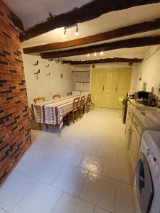 a kitchen with a table and chairs in a room at Chambre privée chez l'habitant, Les Maisons de Gaia in Tuchan
