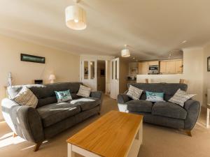 a living room with two couches and a table at 13 Great Cliff in Dawlish