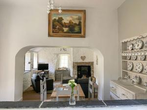 a living room with a couch and a table at Liam Cottage - Cv13 in Saint Cleer