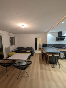 a living room with a couch and a table and chairs at Appartement T3 - Relax aux portes des 24h du Mans in Le Mans