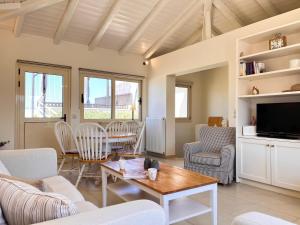 a living room with a couch and a table at Sea Breeze - Home with a View in Bouzéïka