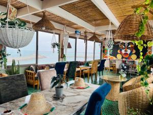 a restaurant with tables and chairs and a view of the ocean at Art Ryad space in El Jadida