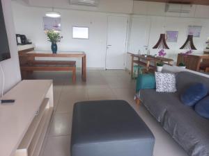 a living room with a couch and a table at Vista Serra e Mar in Bertioga
