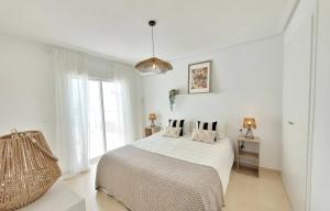 a white bedroom with a bed and a large window at Casa de la Suerte in San Fulgencio +18 photos