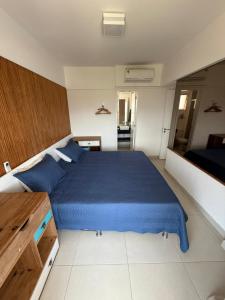 a bedroom with a blue bed in a room at Vista Serra e Mar in Bertioga +23 photos