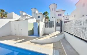 a villa with a swimming pool and a house at Casa de la Suerte in San Fulgencio
