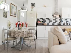 a kitchen and dining room with a table and chairs at The Duck House in Ruckinge