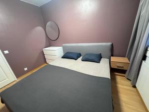 a bedroom with a bed with two blue pillows at Park View Apart in Kouvola