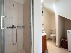 a bathroom with a shower and a toilet at Sea Breeze - Home with a View in Bouzéïka +48 photos