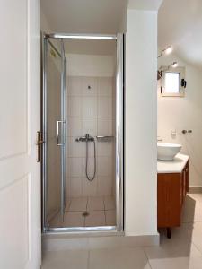 a bathroom with a shower and a sink at Sea Breeze - Home with a View in Bouzéïka
