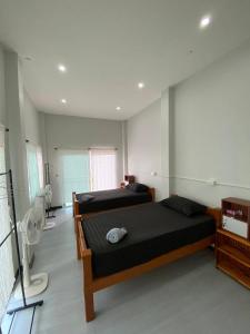 Postel nebo postele na pokoji v ubytování Phu Aunna