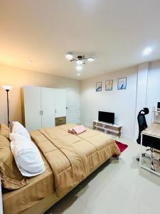 a bedroom with a large bed and a television at Vibe Phuket Relax in Town in Phuket Town +74 photos