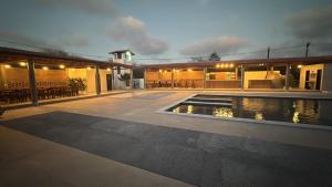 a house with a swimming pool at night at Da terra Altos in Aracati