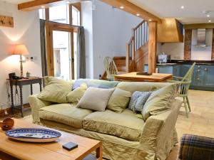 a living room with a couch and a table at The Barn in Greystoke