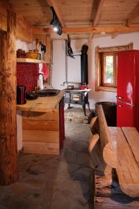 a kitchen with a red refrigerator and a table at Leśna Kopuła in Krempna
