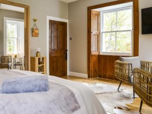 a bedroom with a bed and a window at Riverside Cottage in Blair Atholl +17 photos