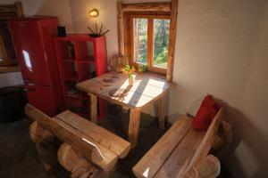 a table and two benches in a room with a window at Leśna Kopuła in Krempna +28 photos