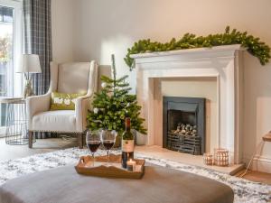 a living room with a christmas tree and wine glasses at Dales Retreat in Skipton