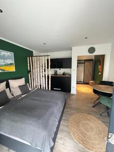 a bedroom with a large bed and a kitchen at Ferienwohnungen mit Feldblick in Schwerin