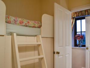 a room with a bunk bed and a window at Pear Tree Cottage in Bowness-on-Windermere +2 photos