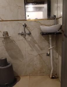a bathroom with a sink and a mirror at Hotel Kaushalya in Ayodhya