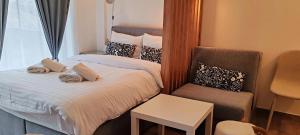 a hotel room with two beds and a chair at Apartman Aska - Residence Hill in Kopaonik +31 photos