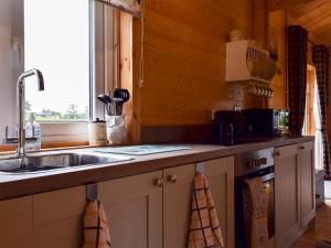 a kitchen with a sink and a counter top at Pheasant Lodge - Uk33402 in Hungerton +10 photos