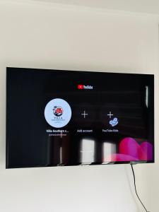 a microwave screen with three bottles of wine at Villa southern coast in Kamburugamuwa