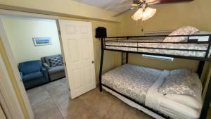 a bedroom with two bunk beds and a couch at Four Bedroom Two Level Home Near Beach in South Padre Island +113 photos