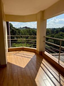 a balcony with a large window with a view at Emeli Hotel Luxury Suite in Nairobi +8 photos
