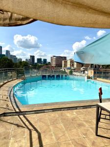 a large swimming pool on top of a building at Emeli Hotel Luxury Suite in Nairobi