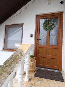 a front door of a house with a wreath on it at Studio Apartman Ivan in Otočac